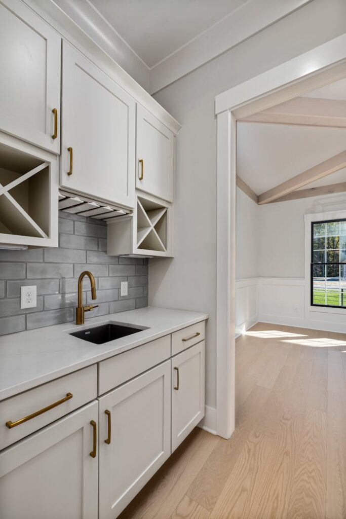 Bright and spacious modern kitchen featuring elegant cabinetry and natural lighting, perfect for contemporary homes.