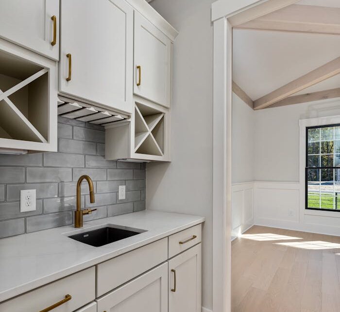 Bright and spacious modern kitchen featuring elegant cabinetry and natural lighting, perfect for contemporary homes.